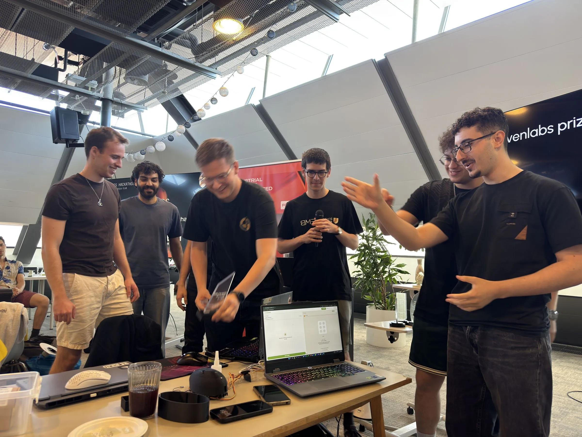 The team and the build, ElevenLabs prize banner behind us