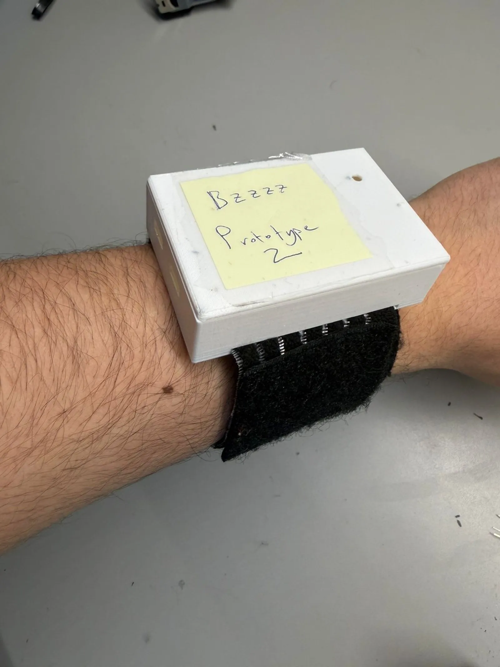 Prototype 2, a white printed box on a velcro strap with a handwritten label